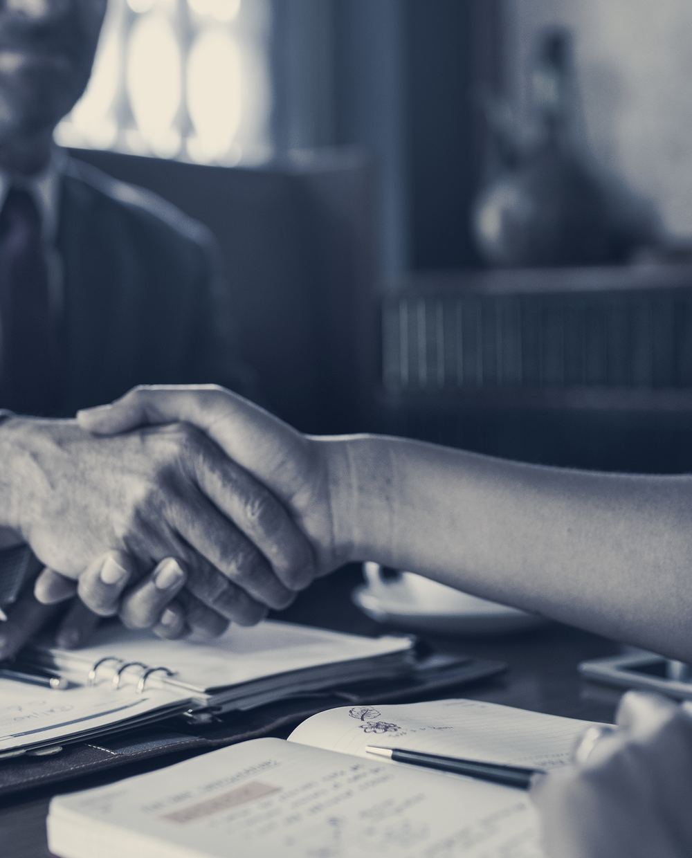 An attorney shaking hands with a client in an office