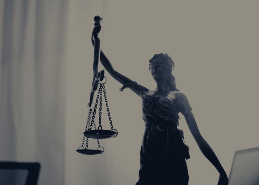 A bronze figure of Justice holding scales